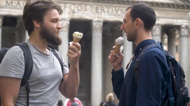 Two Travel Companions Eating Gelato In Old Italian Town.