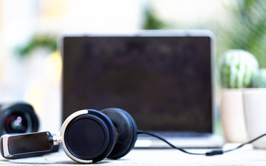 headphones with laptop computer on a bright interior room background