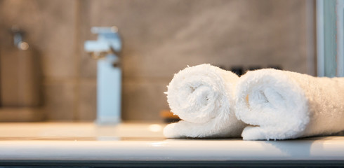 Luxury bathroom sink and white towels. Closeup view with details