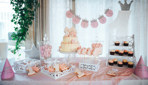 Pink candy bar for first birthday. Sweet table and big cake for first birthday