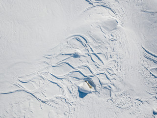 Aerial view of ski tracks in snow in alpine region