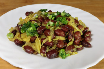 Stewed red beans with fried onions. Vegan food - red and black beans with fried onions, fried on an olive oil.