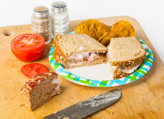 Meatloaf Sandwich with ingredients on Cutting Board with Butcher Knife