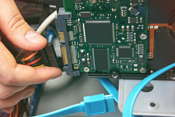 Plugging in power cable connection to HDD.