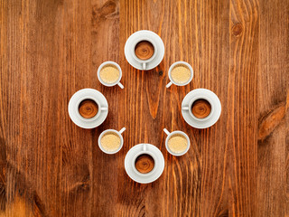 Some coffee cups on wooden table, top view, copy space