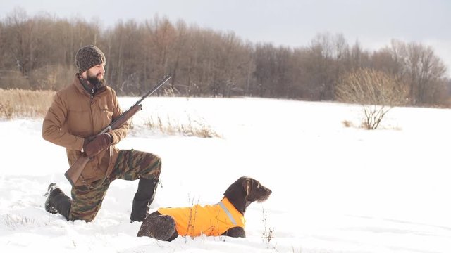 awesome young man with his dog during the hunting. side view shot. hobby, lifestyle