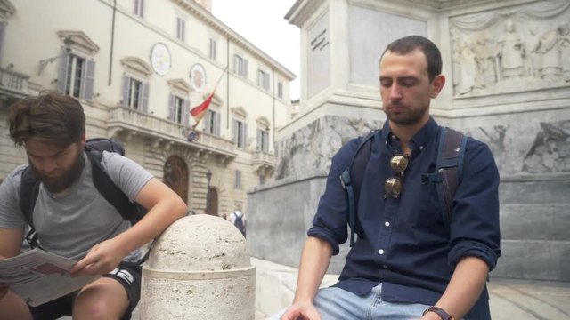 Two Travelling Companions Resting In Old Town.