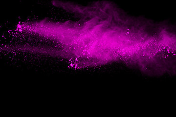Freeze motion of purple powder exploding on black background.