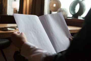 the girl holds in hand the magazine model the A4 format