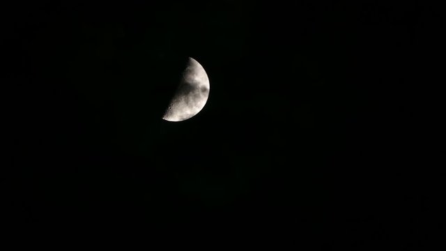 Crescent moon motion, with some clouds passing by in front, giving a sense of  fantasy and mystery.Time Lapse.