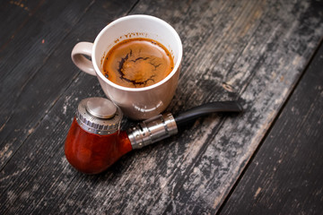 Electronic pipe, advanced personal vaporizer, e-cigarette mod and cup of coffee on rustic wooden table