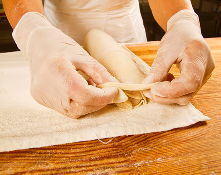 human hands cooking homemade strudel