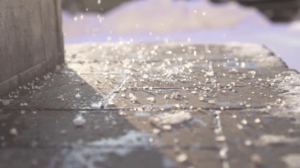 Technical salt reagent on the steps in winter close up,slow mo