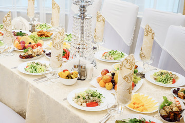 table set service with silverware and glass stemware at restaurant before party