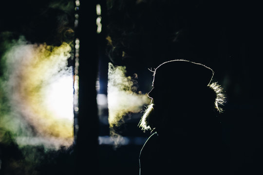 Silhouette Of A Person Exhaling Frosty Breath