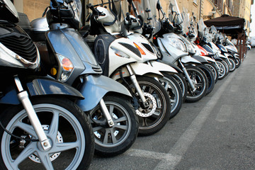 Fototapeta na wymiar parking of scooters in the Italian Milan - Image