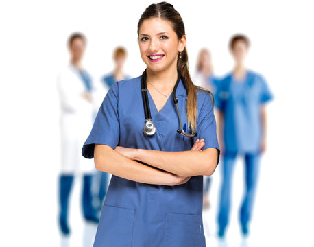 Smiling nurse portrait against a medical team