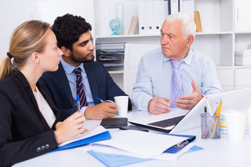 Office workers are working together at computer