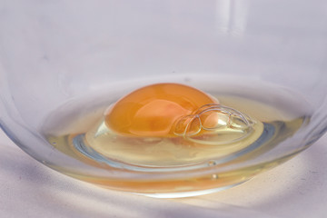 Close up of eg in a glass mixing bowl