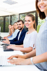 Side view of smiling successful business people during daily work in modern co-working space