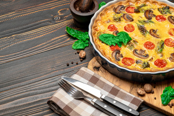 Baked homemade quiche pie in ceramic baking form