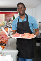 Butcher working behind counter