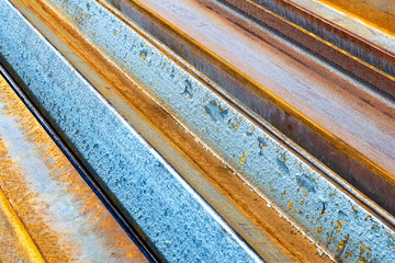 Rusted metal. Yellow and blue diagonal stripes background. Abstract diagonal striped bacground