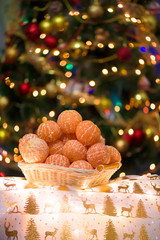 mountain tangerines on the background of the Christmas tree. Christmas photo, cleared tangerines, in the background Boke from garland