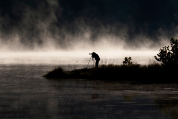 Photography during early morning fog overlooking a lake.