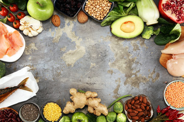 Healthy food clean eating selection. fruit, vegetable, seeds, superfood, cereals, leaf vegetable on rustic background