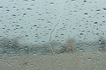 water drops on front glass of car, rainy day