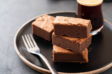 Double Chocolate Brownies. Homemade chocolate fudge brownies with chocolate chips and black background. Copy space.