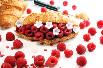 Delicious breakfast with fresh croissants and ripe berries