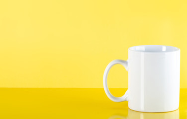 White cup mug drink on yellow background