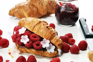 Delicious breakfast with fresh croissants and ripe berries
