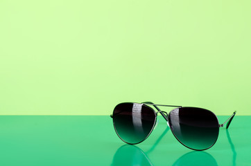 Sunglasses fashion summer accessory on green background