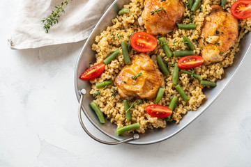 Grilled chicken thighs with bulgur, asparagus beans and tomatoes. Delicious lunch.