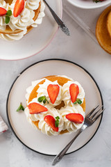 Strawberry cake with vanilla cream on white background. Copy space.