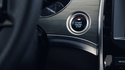 Car Start-Stop Engine Button of a modern car in the interior of the expensive car