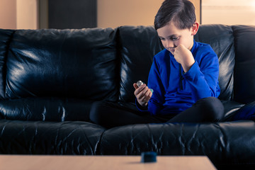 Little boy looking at asthma inhaler