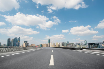 Empty asphalt road along modern commercial buildings in China,s cities