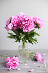 Flowers composition.  Pink peony flowers on wooden background. Mothers day. Flat lay, top view.