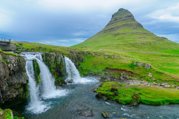 Kirkjufell mountain , and the Kirkjufellsfoss waterfalls