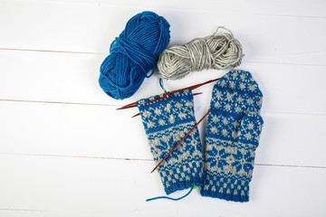 A pair of unfinished Scandinavian inspired stranded colorwork knitted mittens.
