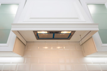 Photo detail of bright light exhaust hood in kitchen