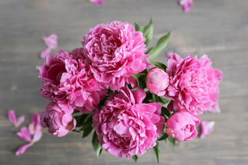 Flowers composition.  Pink peony flowers on wooden background. Mothers day. Flat lay, top view.
