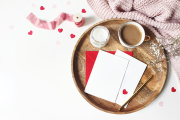 Breakfast still life scene. Cup of coffee, Gypsophila flowers, paper hearts confetti, candle and...