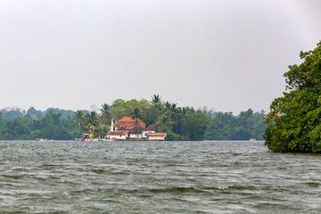 Distant view Kothduwa temple on river in Sri Lanka