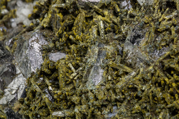 Macro mineral Epidote stone on a white background