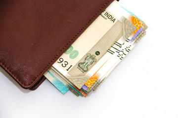 Close up view of wallet with brand new indian 50, 100, 200, 500 rupees banknotes on white background.